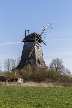 Old abandoned windmill with broken sailsの写真素材
