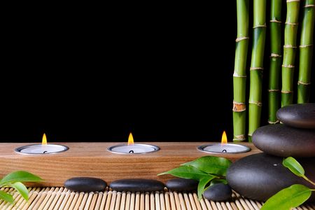 Bamboo,zen stones and candlestck on the black background Bamboo,zen stones and candlestck on the black background