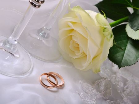wineglass,rose and gold rings on the dressの写真素材
