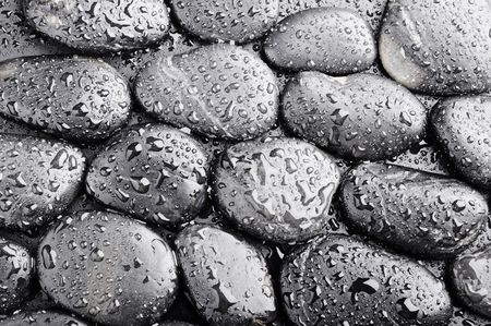 several zen black  stones with water dropsの写真素材