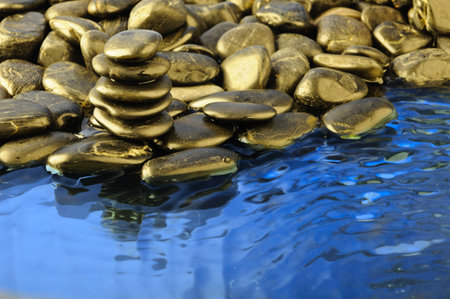 black zen stones in the blue water