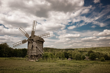 old windmill blue sky and white cloudsの写真素材