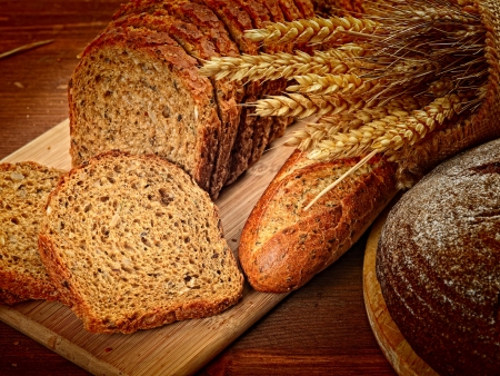 fresh bread  and wheat on the woodenの写真素材