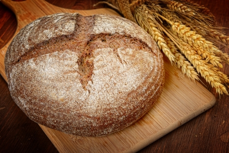 fresh bread  and wheat on the woodenの写真素材