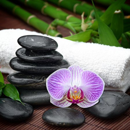 zen basalt stones and orchid on the woodの写真素材