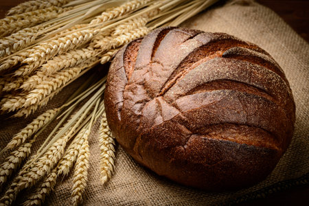 fresh bread  and wheat on the woodenの写真素材