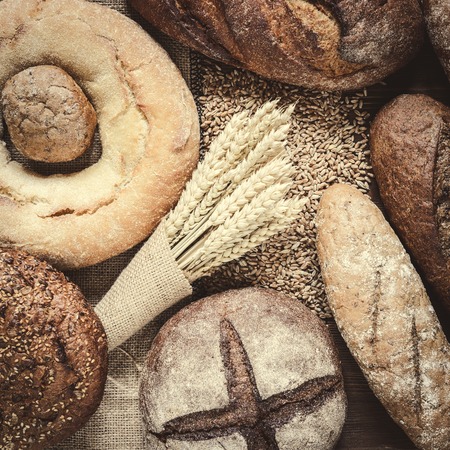 fresh bread  and wheat on the woodenの写真素材
