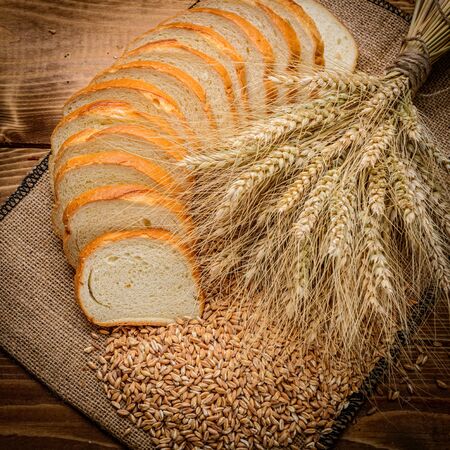 fresh bread  and wheat on the woodenの写真素材