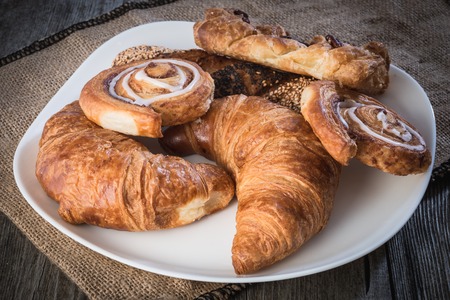 fresh bread  and wheat on the woodenの写真素材