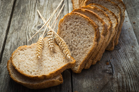 bread and wheat on the wooden board