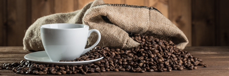 still life with coffee beans and cup on the wooden backgroundの写真素材