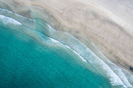 Aerial vertical View Splashing Sea Waves on the Beachの写真素材