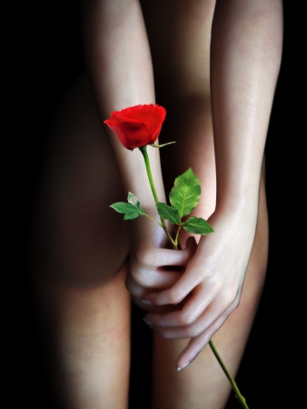 Female s backside holding a rose with a black background  Sensual gift, anniversary, Valentines day concept の写真素材