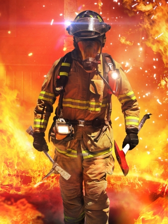 Firefighter searching for possible survivors with tools, tacticle lighting and thermal imaging camera  Part of a firefighter seriesの写真素材