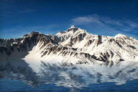Majestic snow covered mountains reflecting in the waterの写真素材