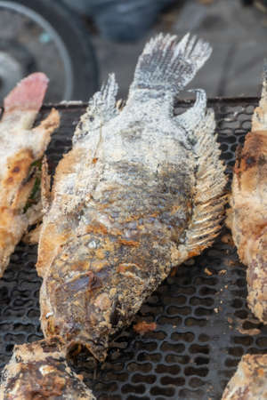 Salted and stuffed fish for sale in Northern Thailand on a grill in iopen marketの写真素材
