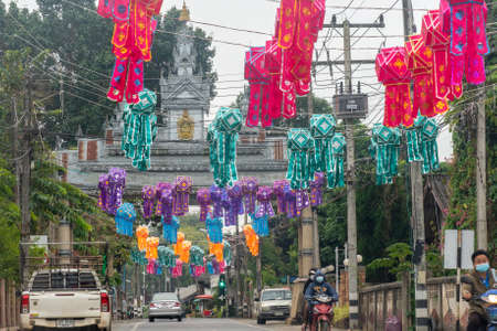 A street in Mae Sariang Town Center with colorful decorations in the sky and welcome gate in distanceのeditorial素材
