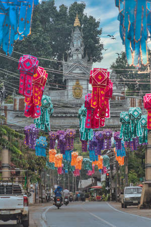A street in Mae Sariang Town Center with colorful decorations in the sky and welcome gate in distanceのeditorial素材