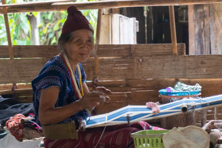 Old Woman on the Loom in Huai Hillside Village, a Rural Northern Thailand near Myanmar Borderのeditorial素材