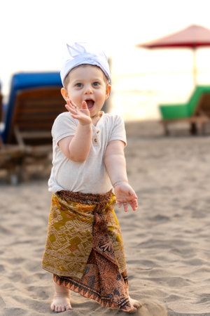 Cute little baby girl playing on the beach at the day time.の写真素材