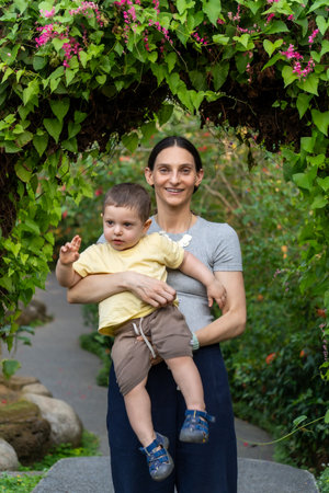 Portrait of a young mother with her son in the park.の写真素材
