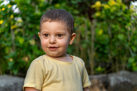 Portrait of a little boy in a yellow t-shirt.の写真素材