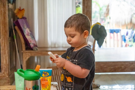 Cute little boy playing with toys in his room at home.