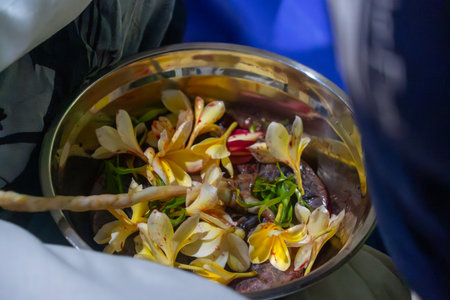 Plumeria flowers in a bowl in a Buddhist monk's templeの写真素材