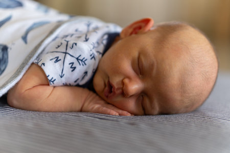 Newborn baby sleeping on the bed, close-up portrait.の写真素材