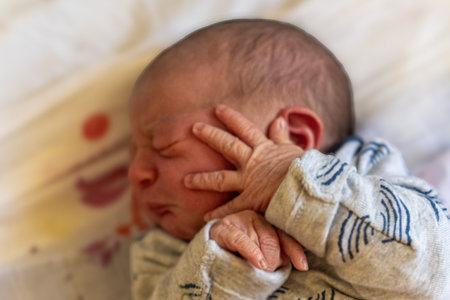 Newborn baby in a hospital bed. Shallow depth of field.の写真素材