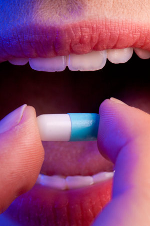 Taking a blue and white capsule.の写真素材