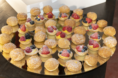 A platter of small berry tarts & puffs.の写真素材