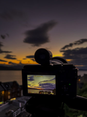 Picture of camera shooting a sunsetの写真素材