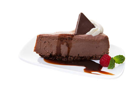 Chocolate cheesecake shot on a white background の写真素材