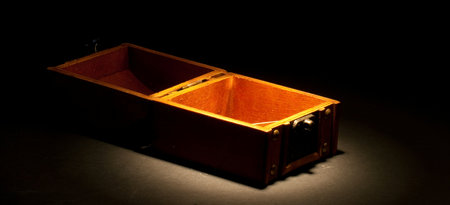 An empty opened chest under a spotlight.の写真素材