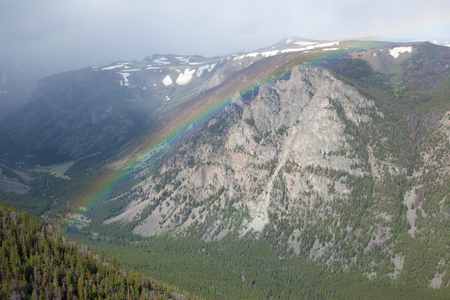 A rainbow over the mountains at Beartooth Pass in Montana.の写真素材