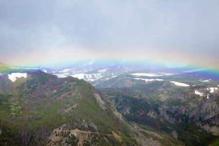 The Absaroka Mountains being spanned by a rainbow.の写真素材