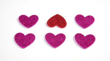 Six glitter hearts on a white background.