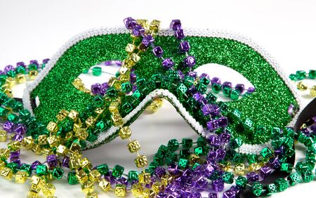A Mardi Gras mask with beads on a white background.の写真素材
