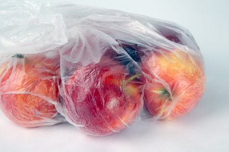 Apples in a bag isolated on a white background.
