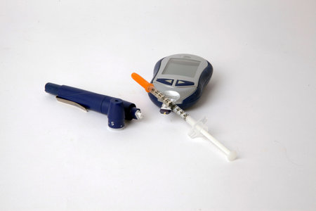 Diabetes testing equipment on a white background.の写真素材
