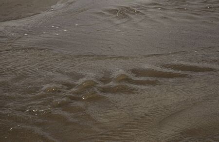The flowing water of the Medano Creek at the Great Sand Dunes National Park.の写真素材