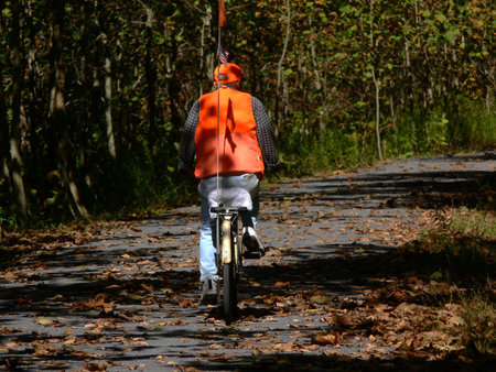 Vintage bike, ridden by vintage biker with safety orange attireの写真素材