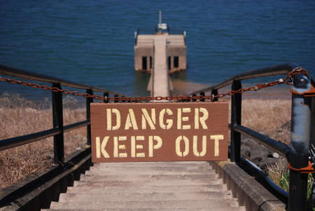 Sign at top of reservoir outflow pipe tower stepsの写真素材