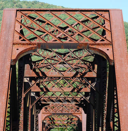 View of old rusty railroad bridge superstructure.の写真素材