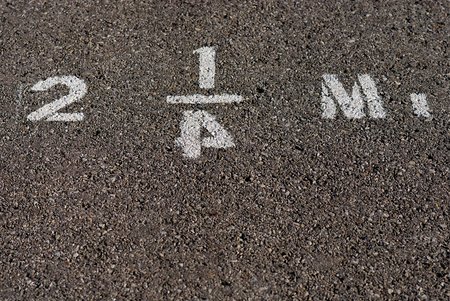 Mileage marker stenciled on pavement with reversed numeral four.の写真素材