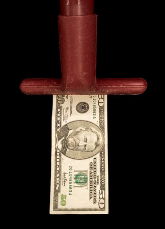 Red vacuum hose nozzle inhaling a U S  50 dollar bill, black iso.の写真素材