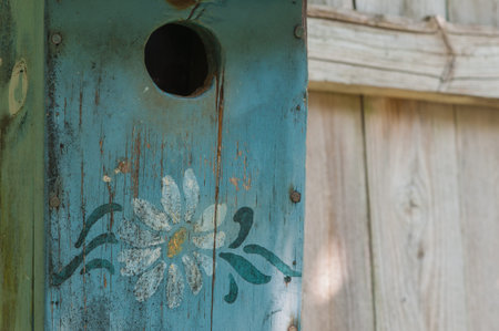 Close-up of old, weathered, cracked bird house, copy space on right.