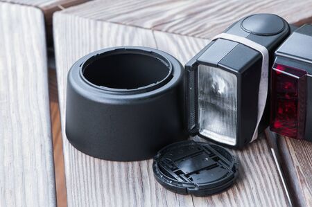 Camera lens hood, lens cap, and flash gun の写真素材