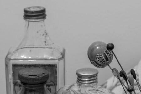 Monochrome view of Victorian era hairpins, with equally old boudoir bottles.の写真素材